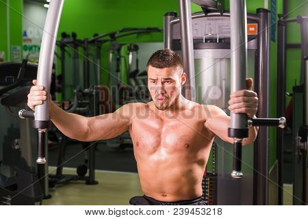 Woman Doing Fitness Training On A Butterfly Machine With Weights In A Gym.
