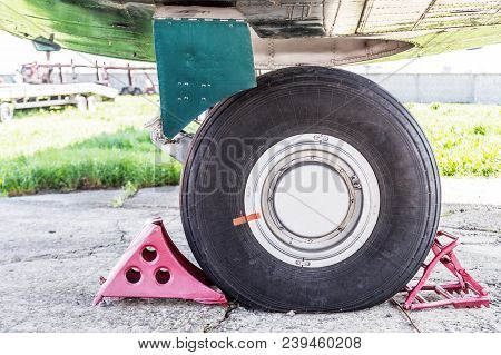 Side Close-up View Of Air Plane Landing Gear. Aircraft Tyre Wear And Replacement.maintenace And Serv