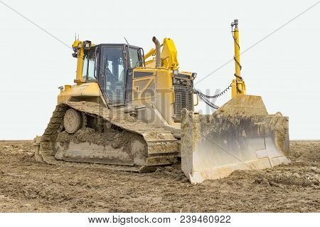 Yellow Bulldozer At A Loamy Construction Site, Partly Isolated In White Back