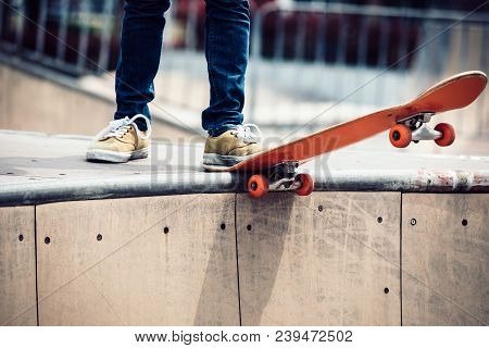 One Skateboarder Legs Sakteboarding On Skatepark Ramp