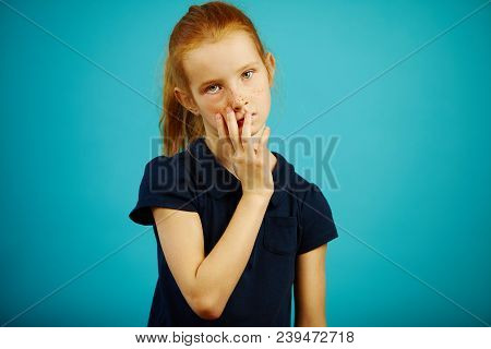 Tired Girl Puts Her Hand To Her Face, Expresses Fatigue And Weariness, Stands On Blue Isolated Backg