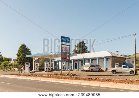 Estcourt, South Africa - March 21, 2018: A Street Scene With Gas Station, Shop And Vehicles At Moorl
