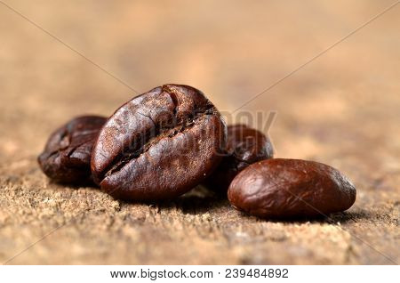 Macro Of Coffee Beans On A Wooden Table