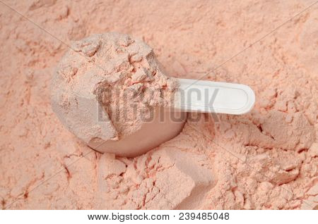 Strawberry Protein Powder In A Measuring Cup