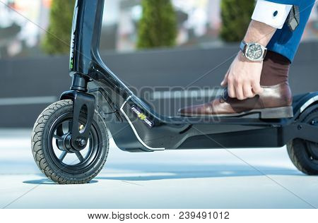 Using Electric Scooter On The Street