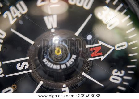 Close Up Of A Naval Compass With Bokeh