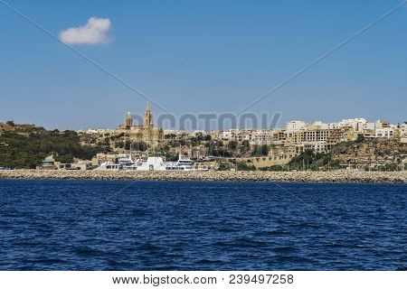 Gozo Island, Malta Gozo Port Landscape. Gozo Channel Line Ferry At Port With Background View Of City