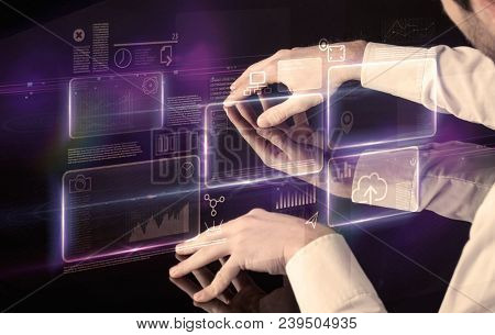 Male hands touching interactive table with purple cloudspace graphic on it 