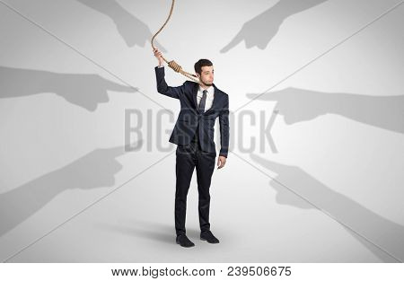 Young businessman trying to suicide with pointing hands concept