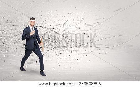 Young suited karate trainer doing karate tricks with chaotic concept