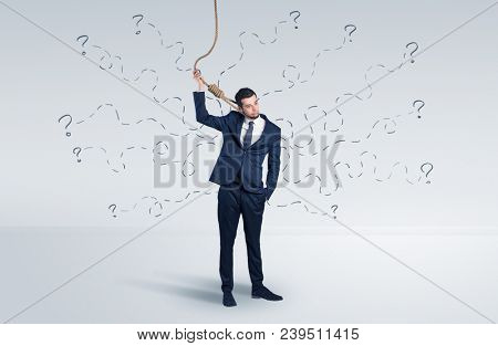Hopeless young businessman trying to suicide with question signs concept