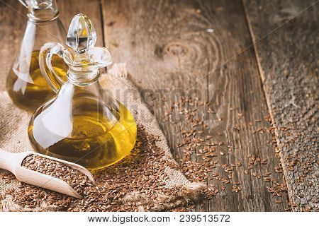 Flax Seeds And Linseed Oil In A Glass Jug On A Wooden Table, Healthy Diet With Omega 3 Fatty Acids