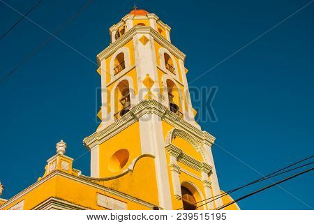 Trinidad, Cuba. The Bell Tower Of San Francisco De Asis Against The Blue Sky.