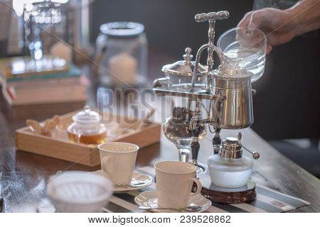 Close Up Of Siphon Vacuum, Coffee Cup And Siphon Vacuum Coffee Maker At Shop.