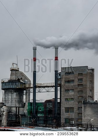 Old Plant Polluting Atmosphere With Two Chimneys.