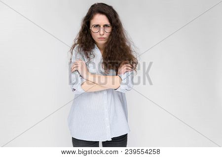 Young Girl With Glasses On A Gray Background. Portrait Of A Young Beautiful Girl. A Charming Girl In