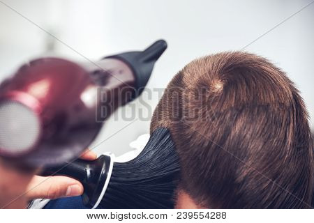 Barber Is Drying A Hair To Caucasian Boy In Barbershop.