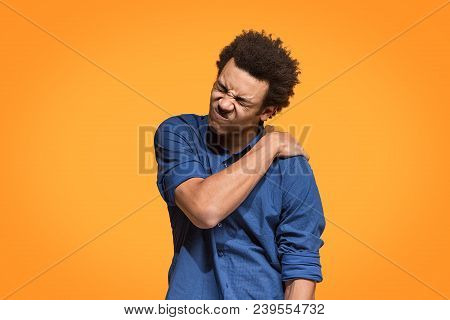 Pain Concept. Beautiful Male Portrait Isolated On Orange Backgroud. Young Emotional Afro Man. Human 
