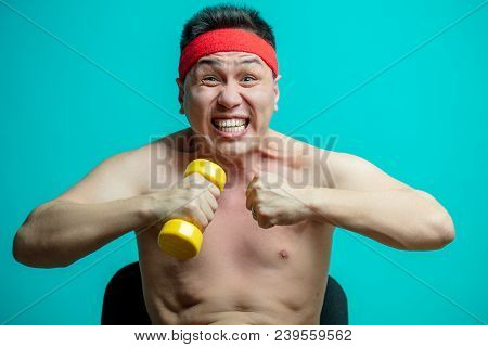 Asian Emotional Man With Naked Torso Exercising With Dumbbells Screaming From Efforts Showing Strong