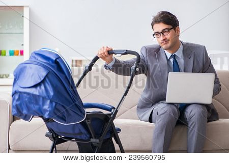 Businessman looking after newborn baby at home and teleworking