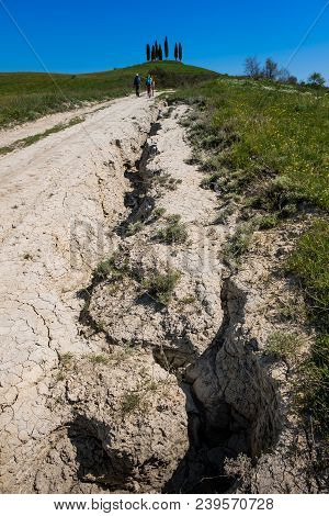 Asciano, Tuscany, Italy - Unknown People Walking Along The Famous White Roads