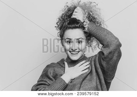 Adorable Excited Young Female With Curly Hair, Keeps Hair Tied In Pony Tail, Dressed In Casual Red S