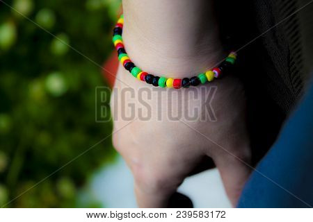 Hand With Bracelet Of Jamaican Style Beads With Hand