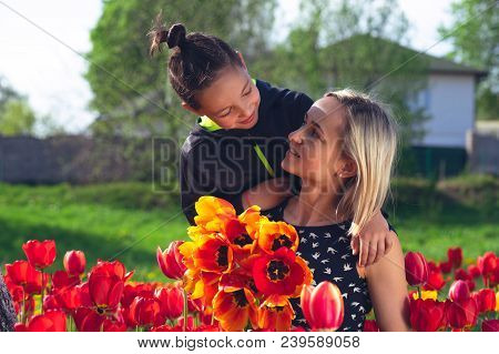 Happy Family In The Red And Yellow Tulips Field