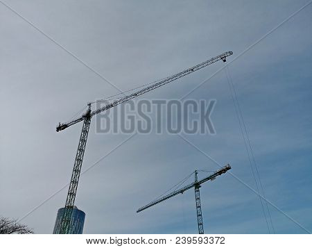 Two Cranes With Blue Sky In The Background Cof