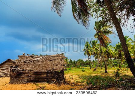 Thatched Coconut Leaf House Or Fishing Hut On Tropical Beach In Rainy Weather. Traditional Or Vintag