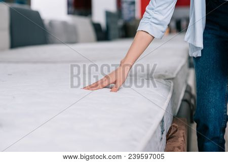 Partial View Of Woman Touching Orthopedic Mattress In Furniture Shop