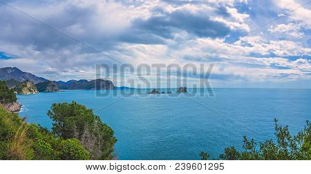 Panoramic View Of The Beautiful Coastline Around Petrovac Town And Small Secluded Monastery On The T