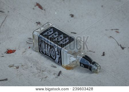 April 22, 2018  Empty Jack Daniels Whiskey Bottle Lying On The Sandy Bank Of The Loxahatchee River I