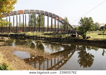 View Of The Beautiful Reflection Created By The Pedestrian Timber Bridge, Over The Sertã River, In S