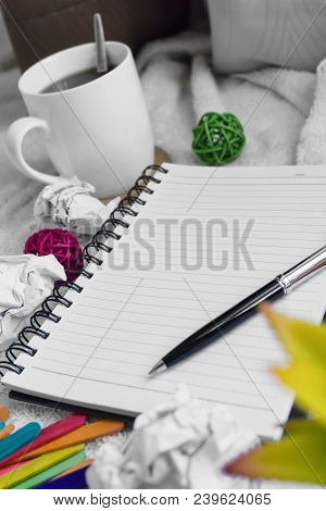 A Mug Of Coffee, Note Pad And Pen On Top Of White Cloth