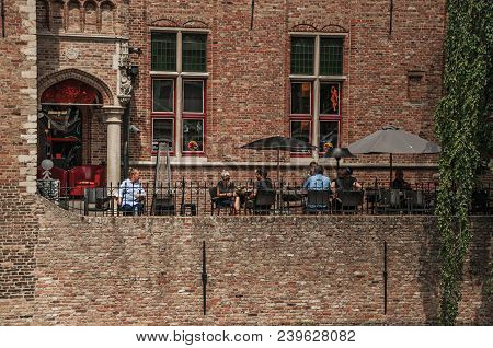 Bruges, Belgium - July 05, 2017. People And Old Buildings On The Canal Edge At Bruges. With Many Can