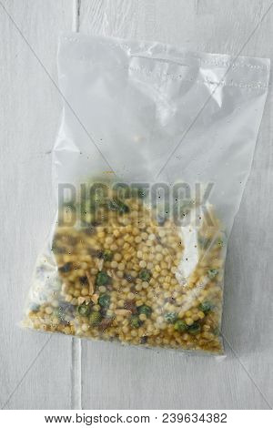Healthy Raw Quick Cooking Grain Package On Wooden Table, Top View. Barley Couscous, Dried Green Peas