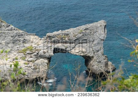Rock In The Ocean At Atuh Beach On Nusa Penida Island, Indonesia. Rocks In A Blue Sea Lagoon With Br
