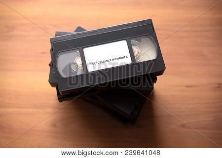 Inaccessible Memories. Memories or recordings of life on obsolete media and cassettes. Stacked VHS vcr video cassette tape with the label 