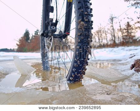 Bike Drowned In Muddy Pool Within Winter Trip. Broken Pieces Of Ice Around Freeze Terain Tyre, Wide 