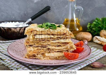 Pie, Casserole Pita With Mushrooms, Cottage Cheese And Cheese On A Plate On A Wooden Background. Lay