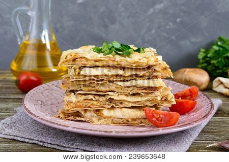 Pie, Casserole Pita With Mushrooms, Cottage Cheese And Cheese On A Plate On A Wooden Background. Lay