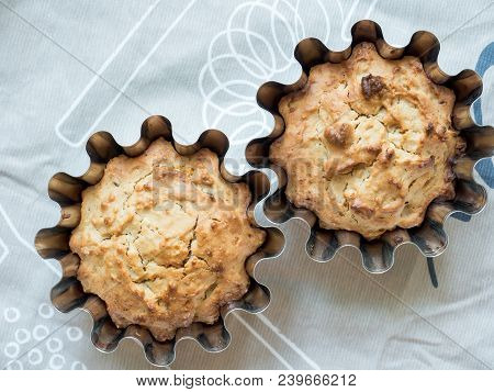 Home-baked Cakes On The Kitchen Table In The Baking Dish