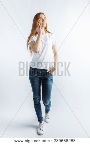 Young Girl Talking On Phone Smiling Isolated On Background