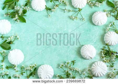 Delicate Frame Of Marshmallows And Cherry Blossoms. Delicious Airy Dessert. Concept Of Light Air Des