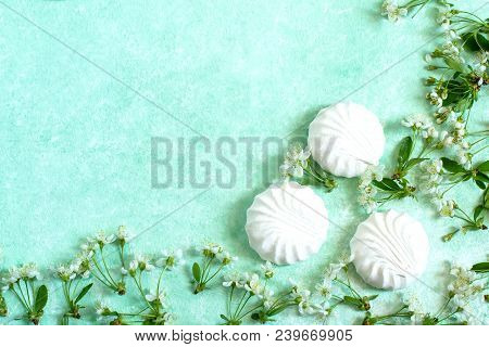 Delicate Frame Of Marshmallows And Cherry Blossoms. Delicious Airy Dessert. Concept Of Light Air Des