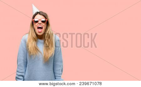 Young woman celebrates birthday stressful, terrified in panic, shouting exasperated and frustrated. Unpleasant gesture. Annoying work drives me crazy