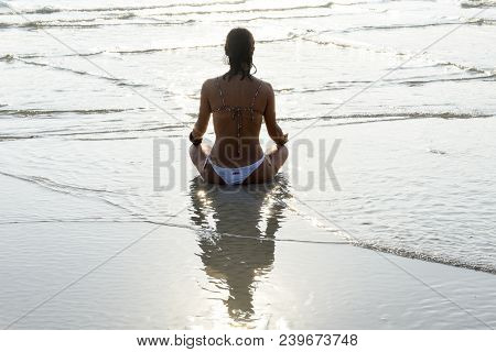 Girl Who Practices Yoga On The Beach