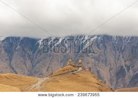 Holy Trinity Church Near The Village Of Gergeti In Georgia