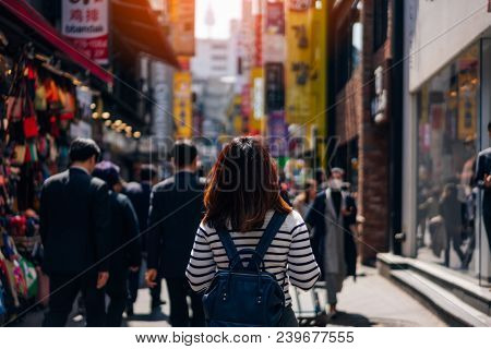 Young Asian Woman Traveler Traveling And Shopping In Myeongdong Street Market At Seoul, South Korea.